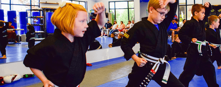 Young students learning martial arts forms at Evo MMA